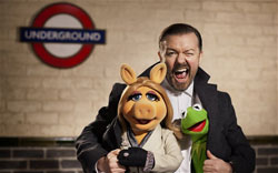 Ricky Gervais gets cozy with Miss Piggy and Kermit the Frog in the top 2014 family film, Muppets Most Wanted