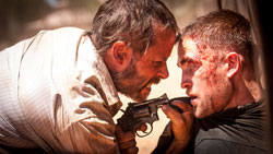 Guy Pearce gets up close and personal with Robert Pattinson in the top drama movie of 2014, The Rover